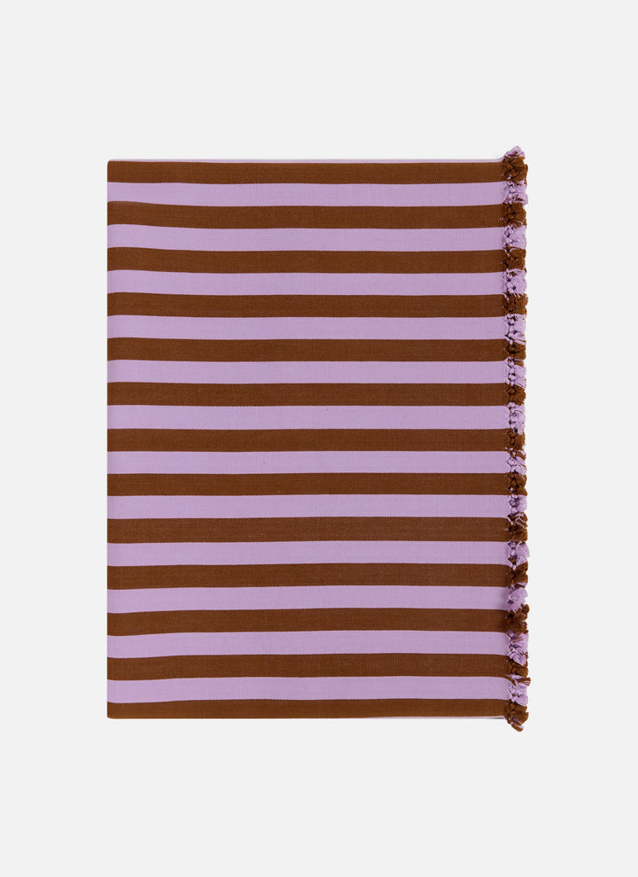 Folded lilac and brown stripe cotton tablecloth shown flat with tassels along one edge