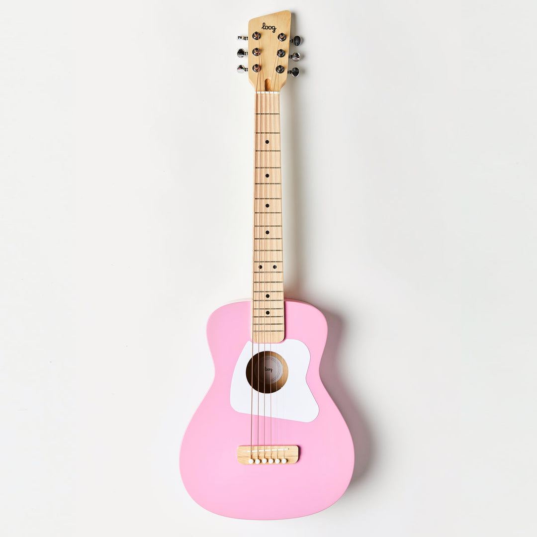 Pink guitar with wooden neck on a white background