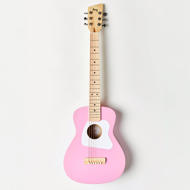 Pink guitar with wooden neck on a white background
