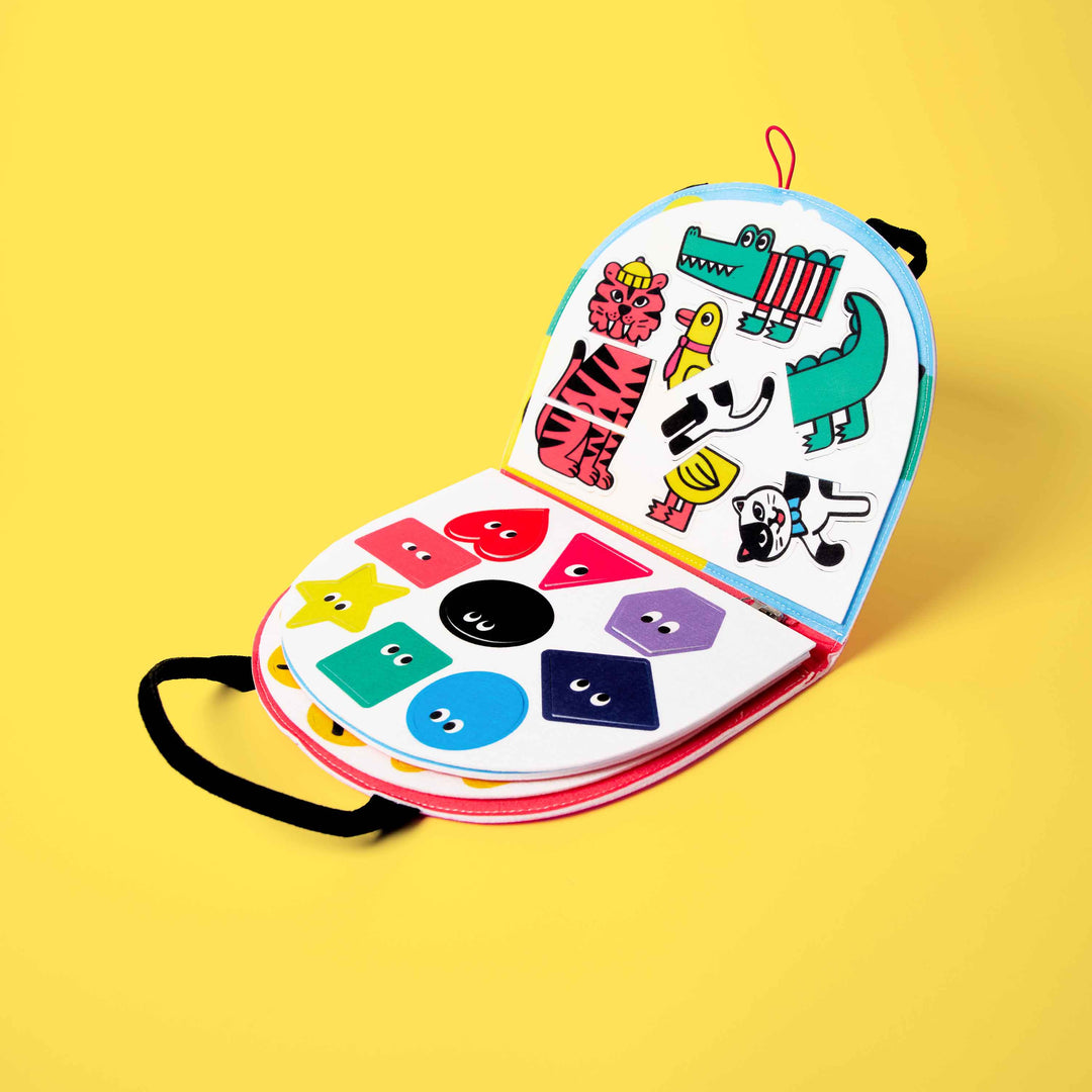 Opened rainbow felt Montessori kit showing color, shape, and fastening activities