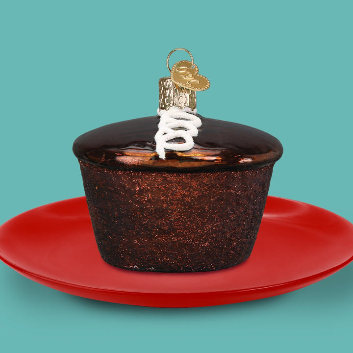 Hostess Cupcake ornament on a red plate against a teal background