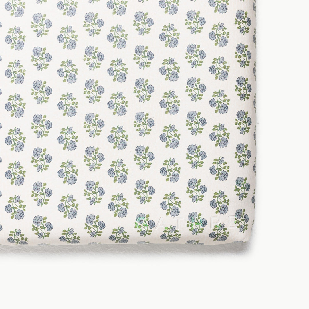 Blue floral block-print padded play mat, close-up of the patterned corner.