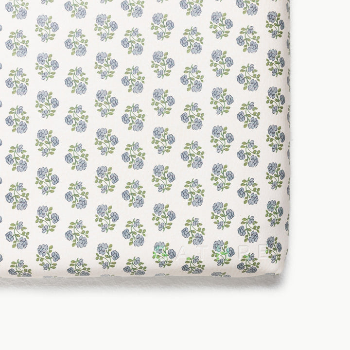 Blue floral block-print padded play mat, close-up of the patterned corner.