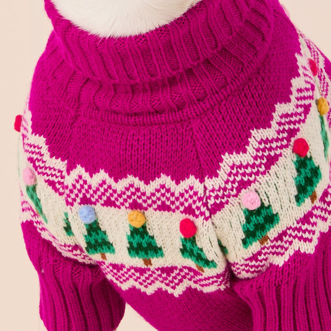 Close-up of the magenta sweater's ribbed neck and cream Fair Isle yoke with green trees.