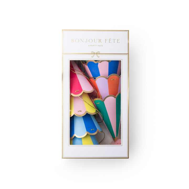 A boxed set of colorful party hats in a white package with gold trim and the text 'BONJOUR FÉTE' and 'PARTY HATS' visible on the front.