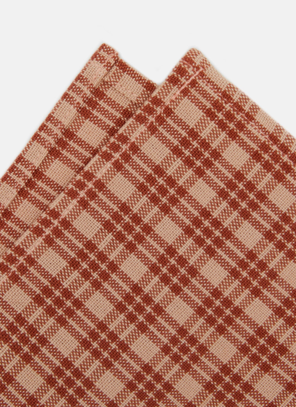 Close-up of the Katherine plaid weave in rust sienna over an oatmeal cotton ground