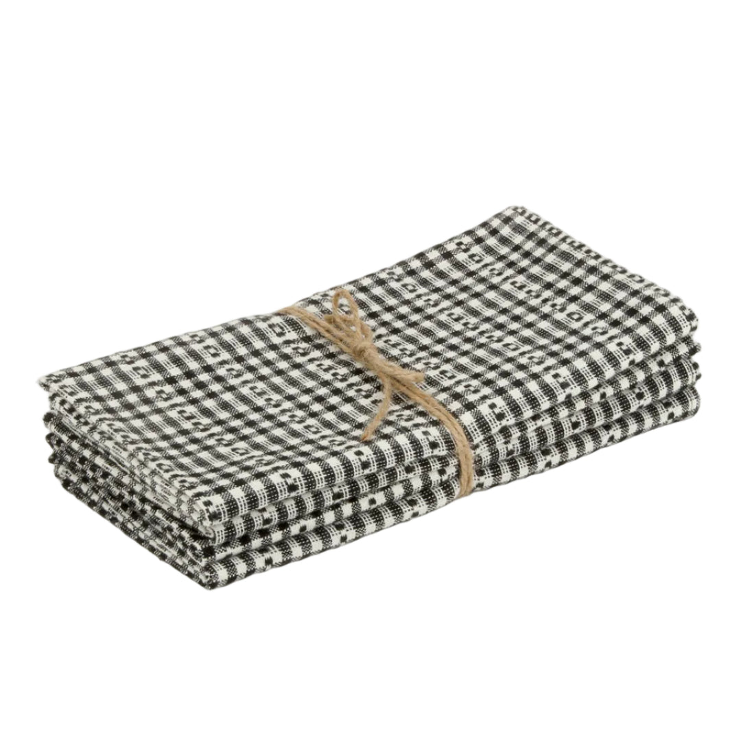 A folded black and white gingham checkered cloth napkin tied with a natural jute twine bow, shown on a light gray background.