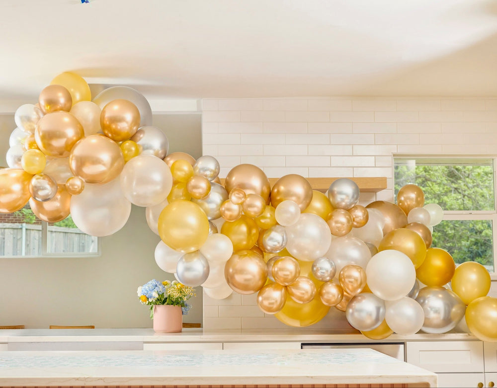 DIY metallic balloon arch kit with three balloon sizes, connector strip, and glue dots