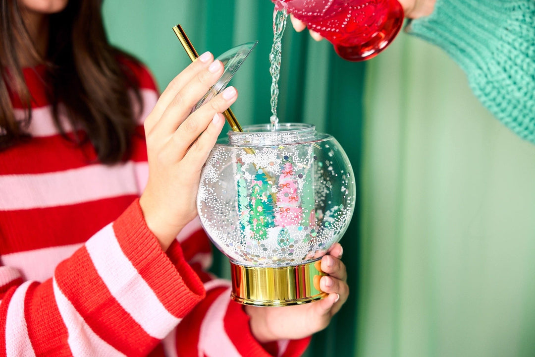 Holiday snow globe sipper with a wintry printed scene and shakeable confetti snow for holiday cocktails
