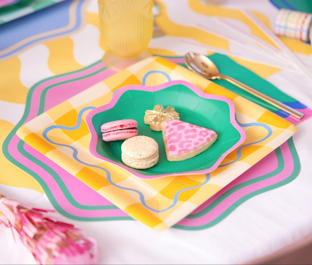 Disposable scalloped placemats in bright assorted colors for birthdays and brunches