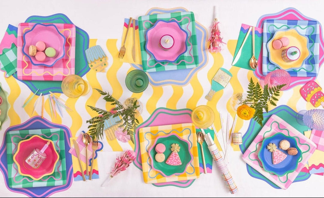Disposable scalloped placemats in bright assorted colors for birthdays and brunches