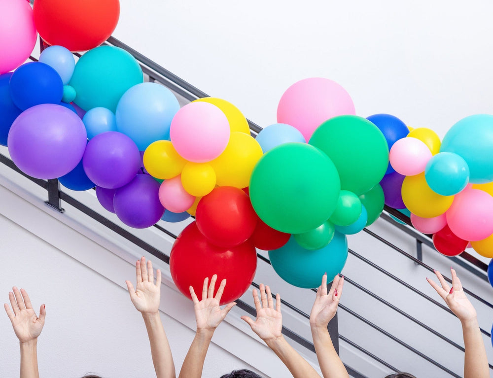 DIY rainbow balloon arch kit with three balloon sizes, connector strip, and glue dots