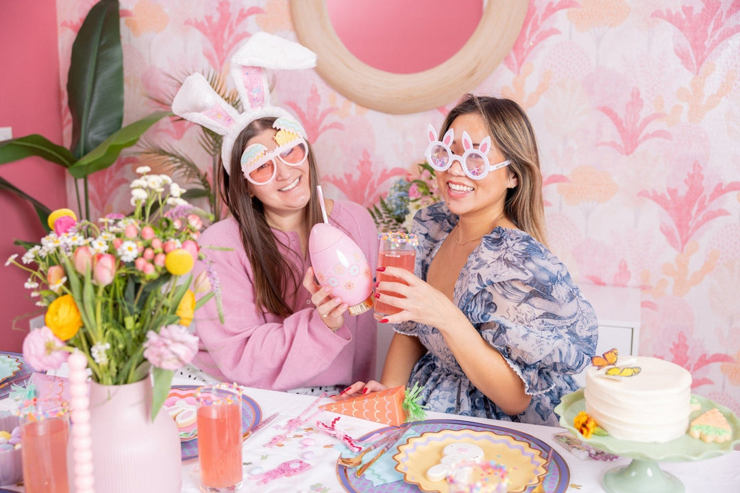 Two friends at an Easter brunch table, one wearing the plush confetti bunny ears
