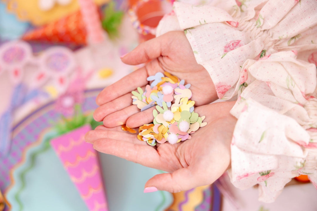 Pastel bunny confetti mixed with white pom poms for Easter tables and baskets