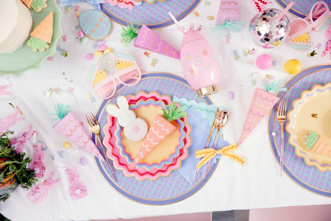 Easter table flat lay with the pink egg sipper, carrot plates, and pastel confetti