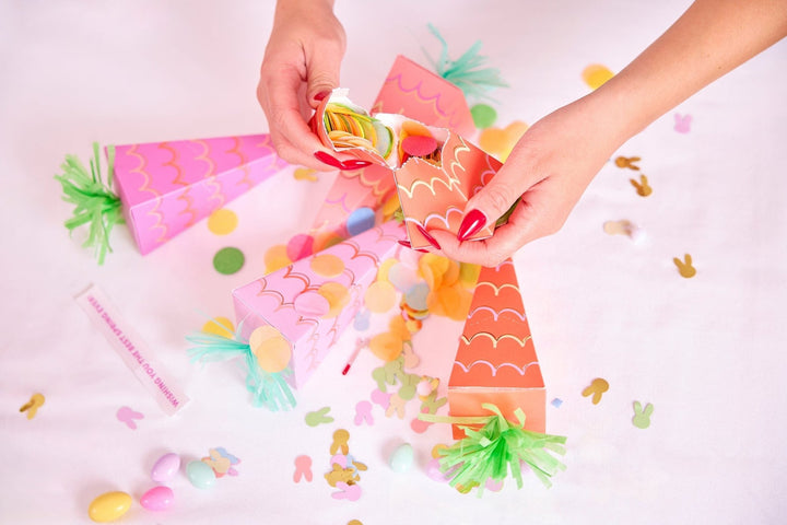 Easter carrot crackers with gold foil papers, confetti, and metal charms