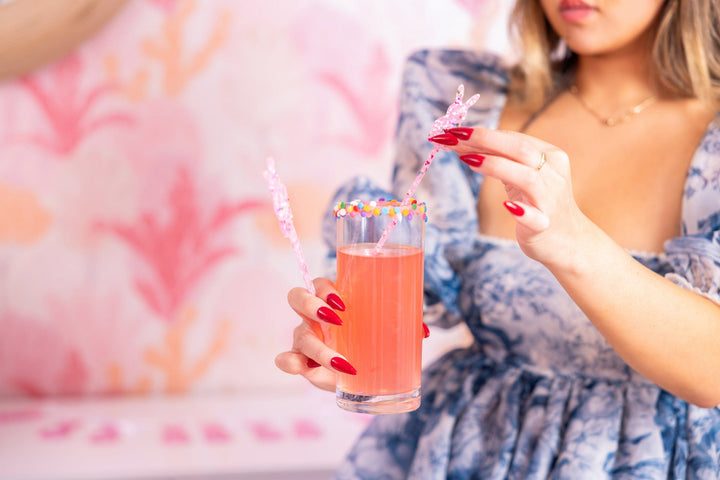 Four bunny shaped drink stirrers in clear pink acrylic filled with confetti and glitter