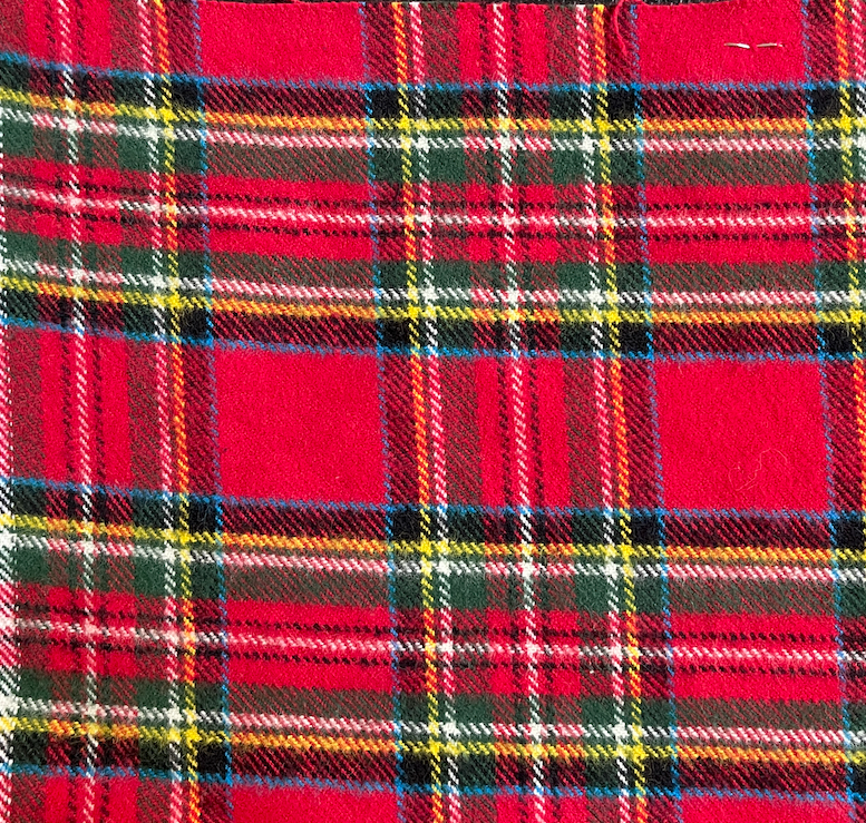 Close-up of the red tartan flannel with green, navy, yellow, and white stripes