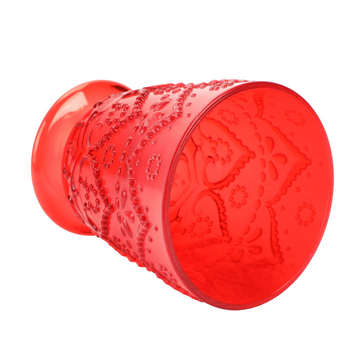 Red pressed-pattern tumbler lying on its side