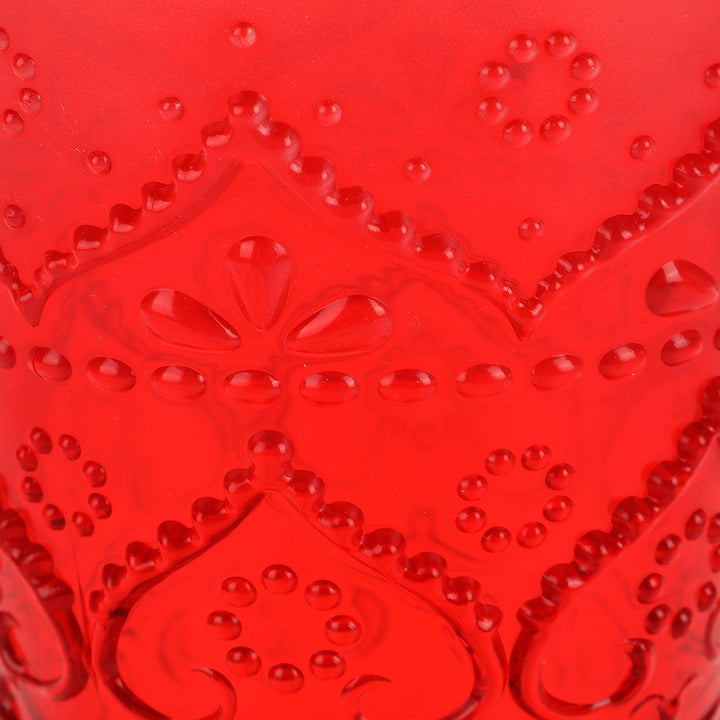 Close-up of the red tumbler's raised scrolls, hearts, and dotted pattern