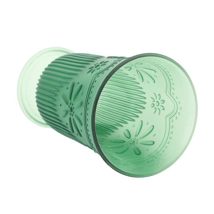 Green daisy-pattern cup lying on its side