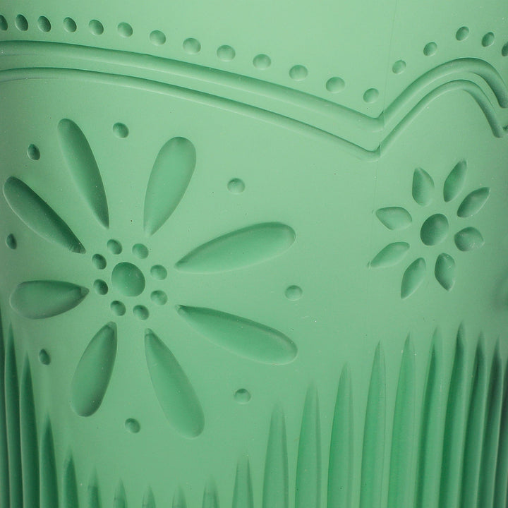 Close-up of the pressed daisy and scallop pattern on the green cup