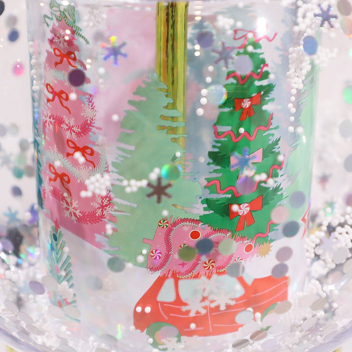 Holiday snow globe sipper, a Christmas tumbler with a shakeable snow scene and gold reusable straw