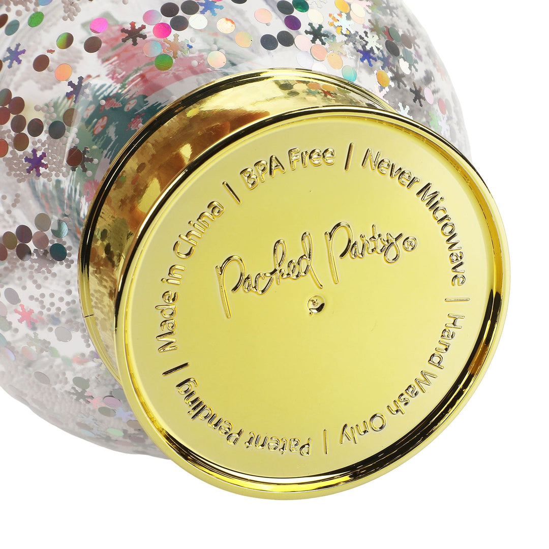 Holiday snow globe sipper cup with a gold straw and shakeable snow scene, a holiday party favor