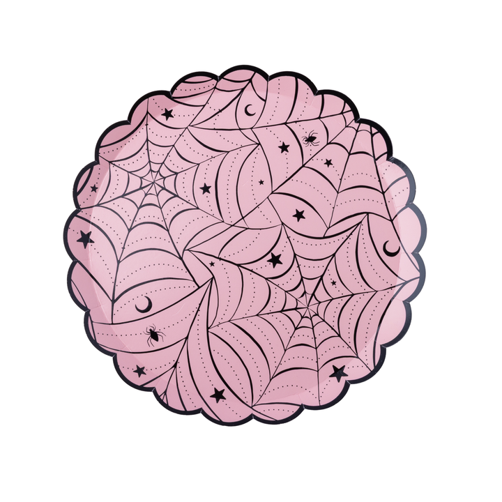 Scalloped-edge paper plates in light pink, decorated with black spiderwebs, stars, and crescent moons, shown on a clean white background.