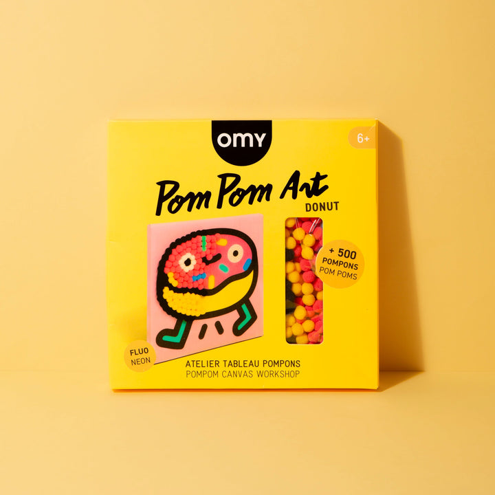 Boxed donut pom pom art kit on a yellow background