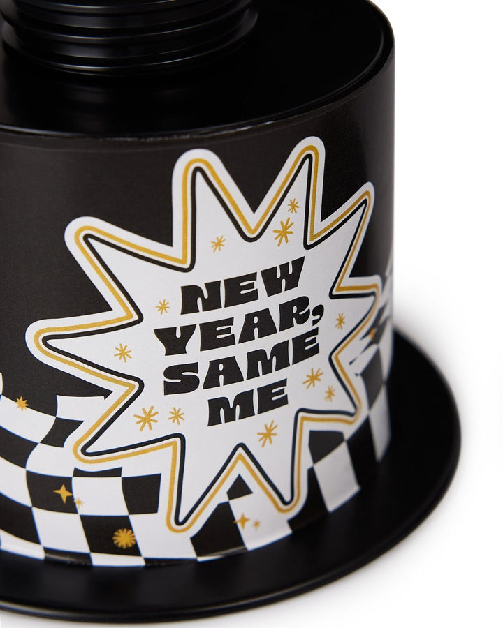 Close-up of the New Year, Same Me starburst label and checkered brim on the top hat cup
