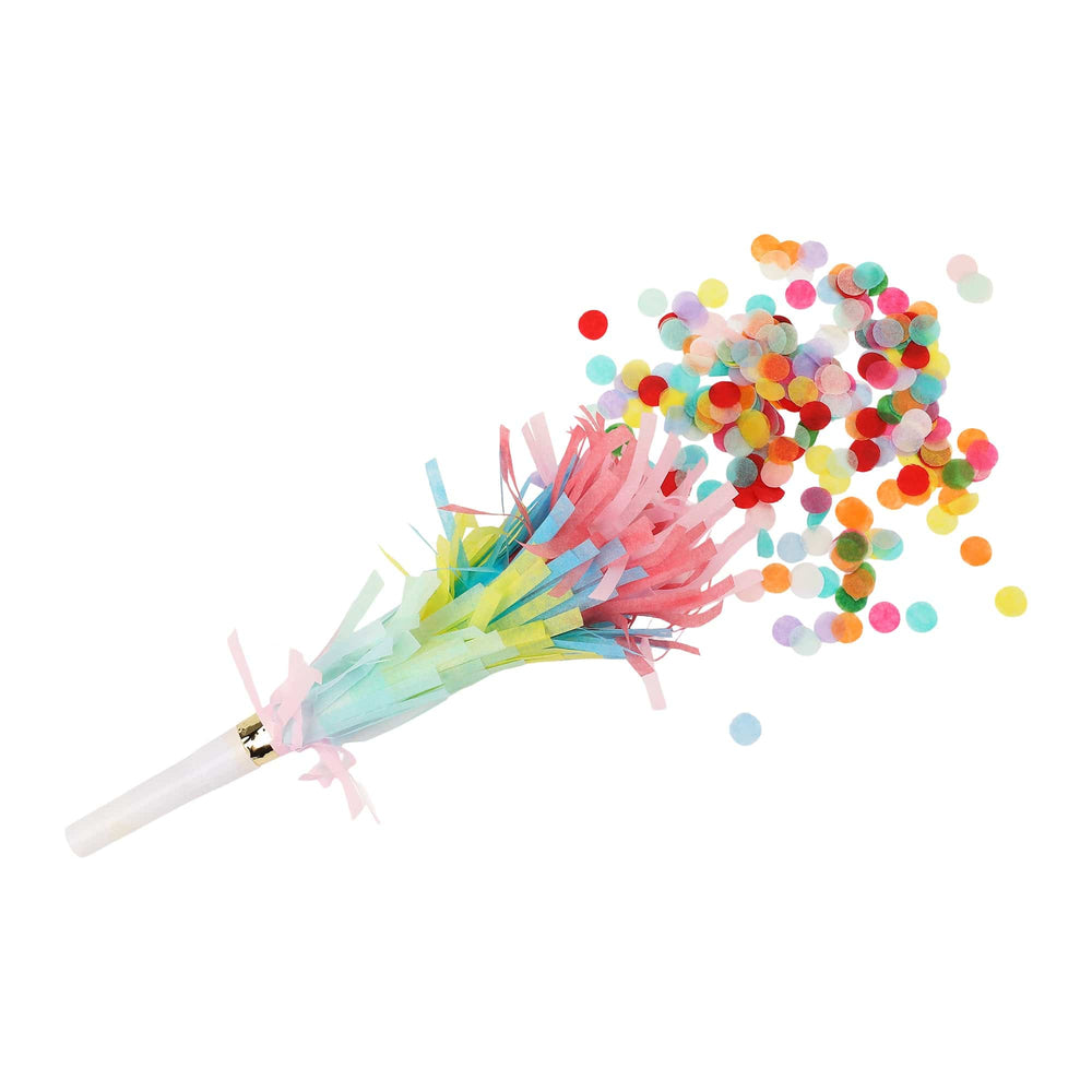 Rainbow fringe party blower with a white mouthpiece bursting multicolor circle confetti, shown on white