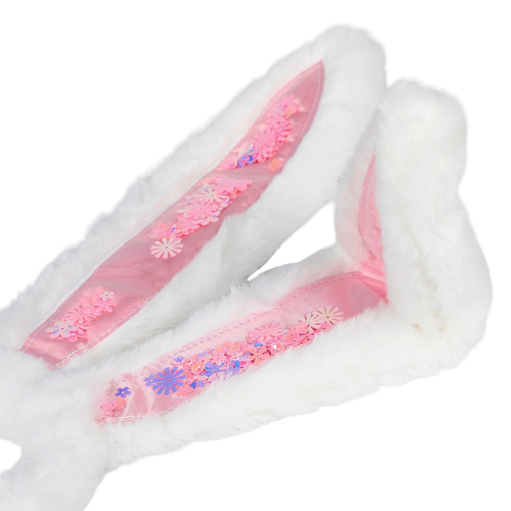 Close-up of the plush bunny ears showing the trapped pink and purple confetti
