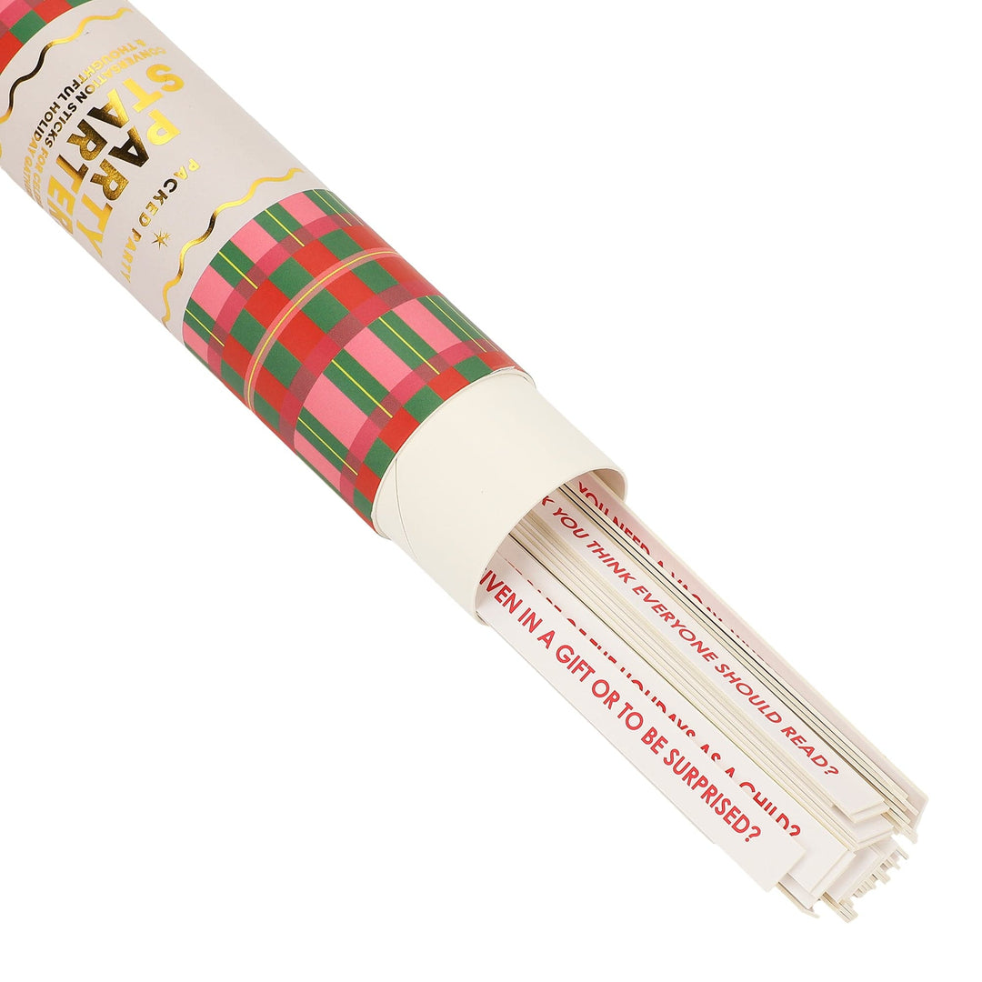 Holiday conversation starter sticks sliding out of a pink, green, and red plaid tube
