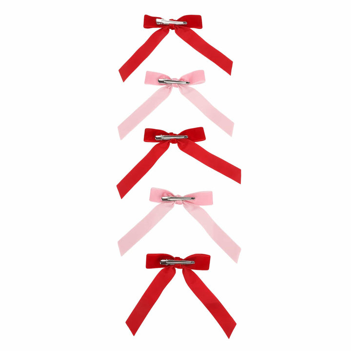 Five velvet bows in alternating red and pink showing the metal clips on the back