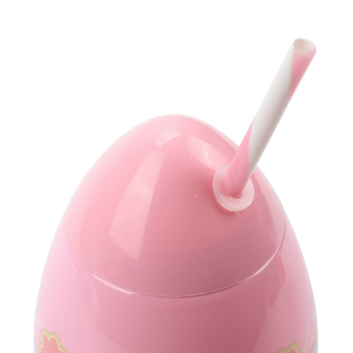 Close-up of the top of the pink egg sipper with its striped straw