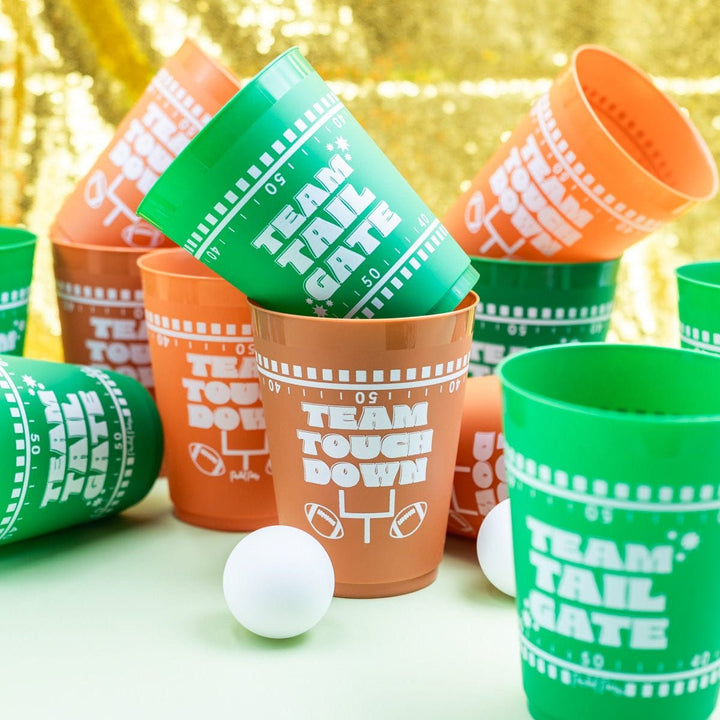 Green Team Tailgate and brown Team Touchdown pong cups tumbled with a ping pong ball