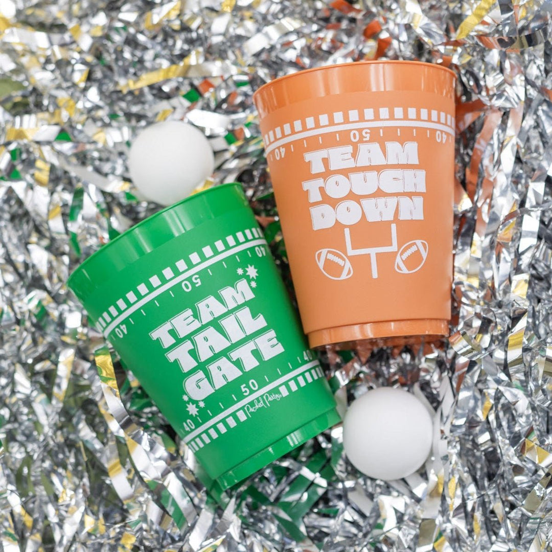 Brown and green pong cups with ping pong balls on silver tinsel