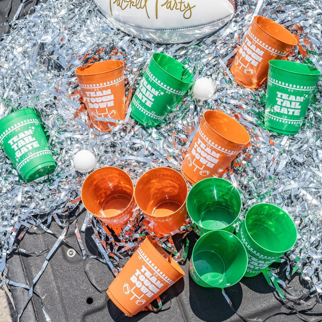 Green and brown pong cups and balls scattered on silver tinsel in a truck bed