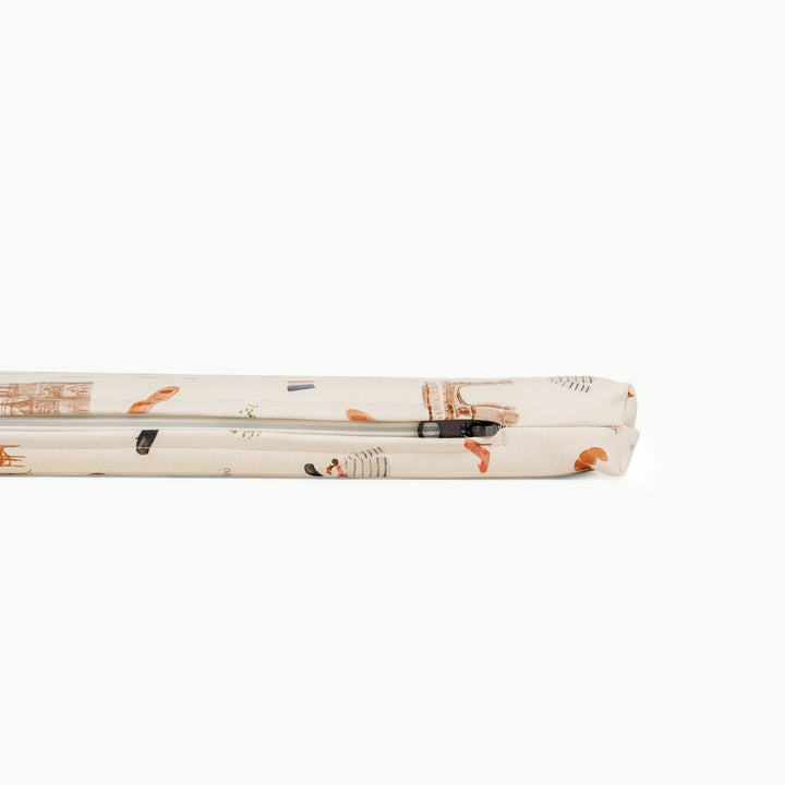 Close-up of the zippered edge on the Paris print padded play mat in cream with Eiffel Tower and cafe motifs