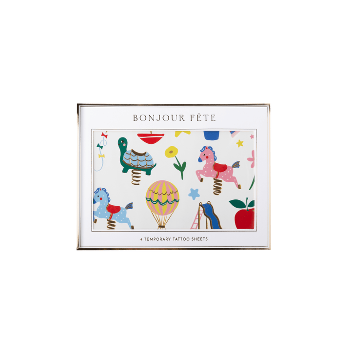 A temporary tattoo sheet featuring a whimsical spring-loaded carnival scene with the text 'BONJOUR FÈTE' at the top and '4 TEMPORARY TATTOO SHEETS' at the bottom, shown on a plain white background.