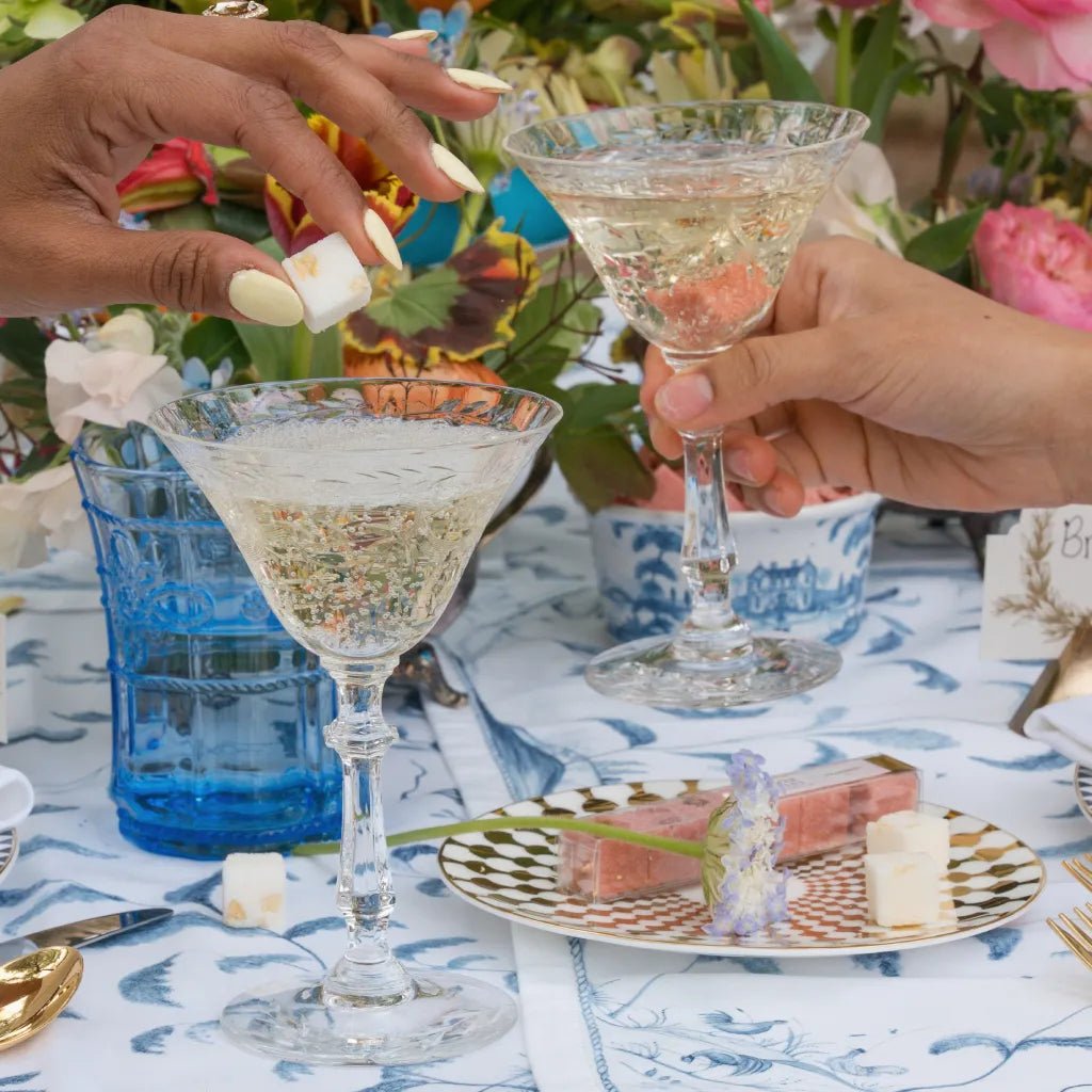 Shimmering mimosa poured over a mixer cube for brunch