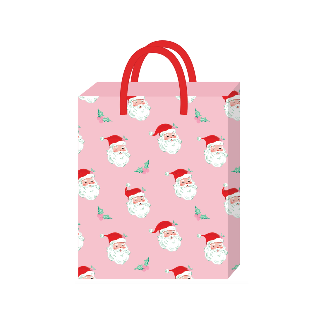 Pink small Christmas gift bag with a vintage Santa face and holly print and red handles