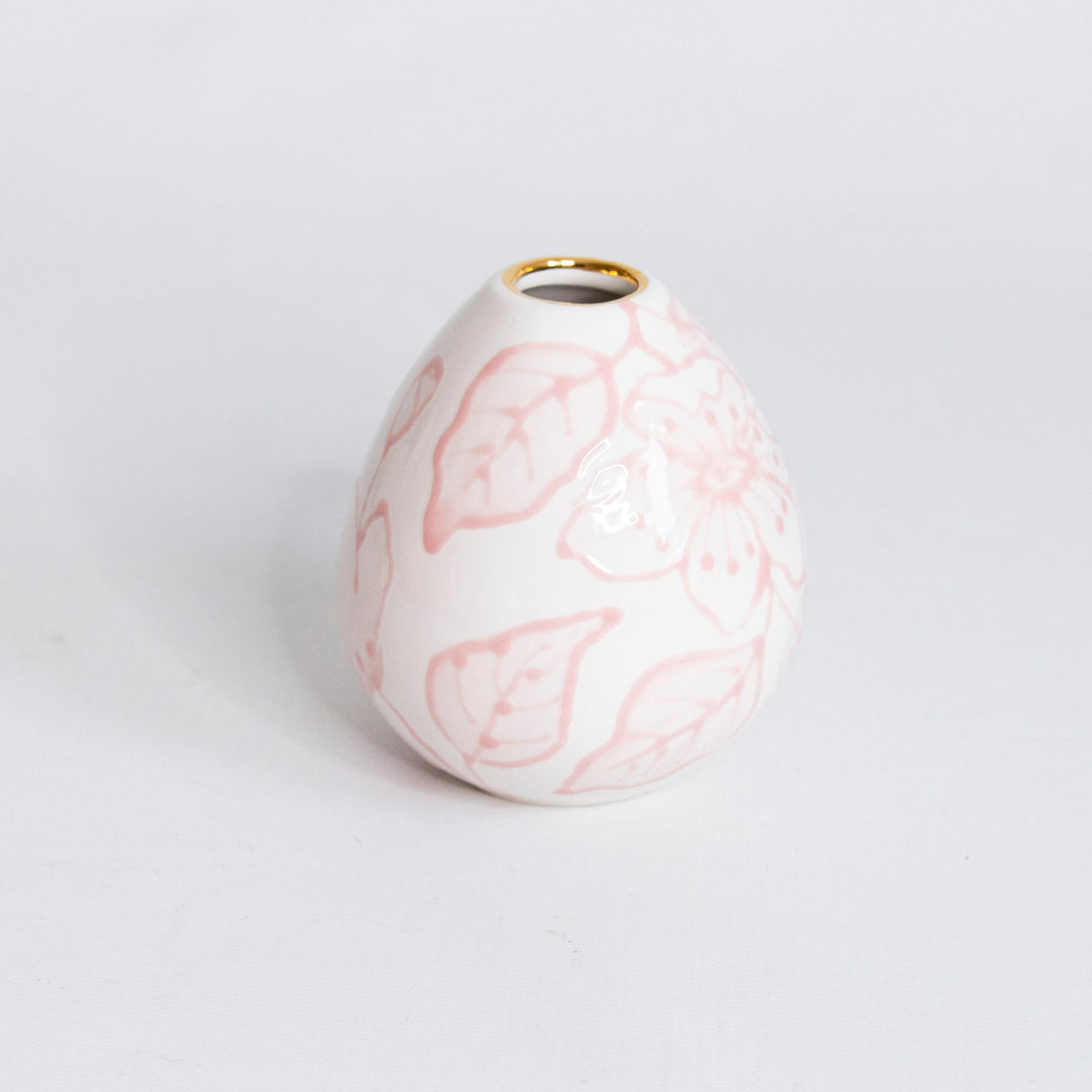 Pale pink outlined floral bud vase with a gold rim, shown empty on a soft gray background