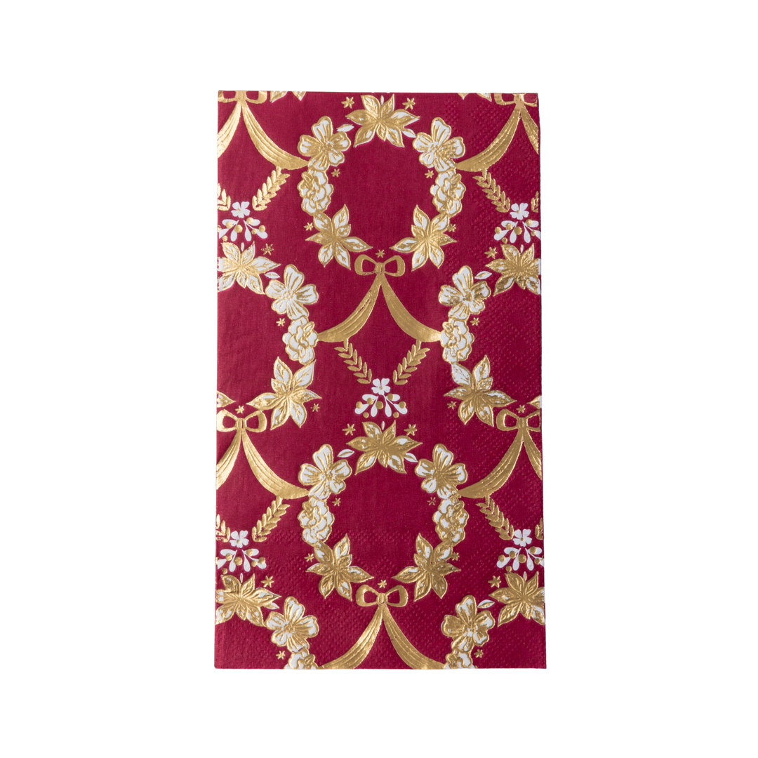 deep red paper napkins featuring a gold floral and vine pattern, with some white floral accents, shown on a clean white background.