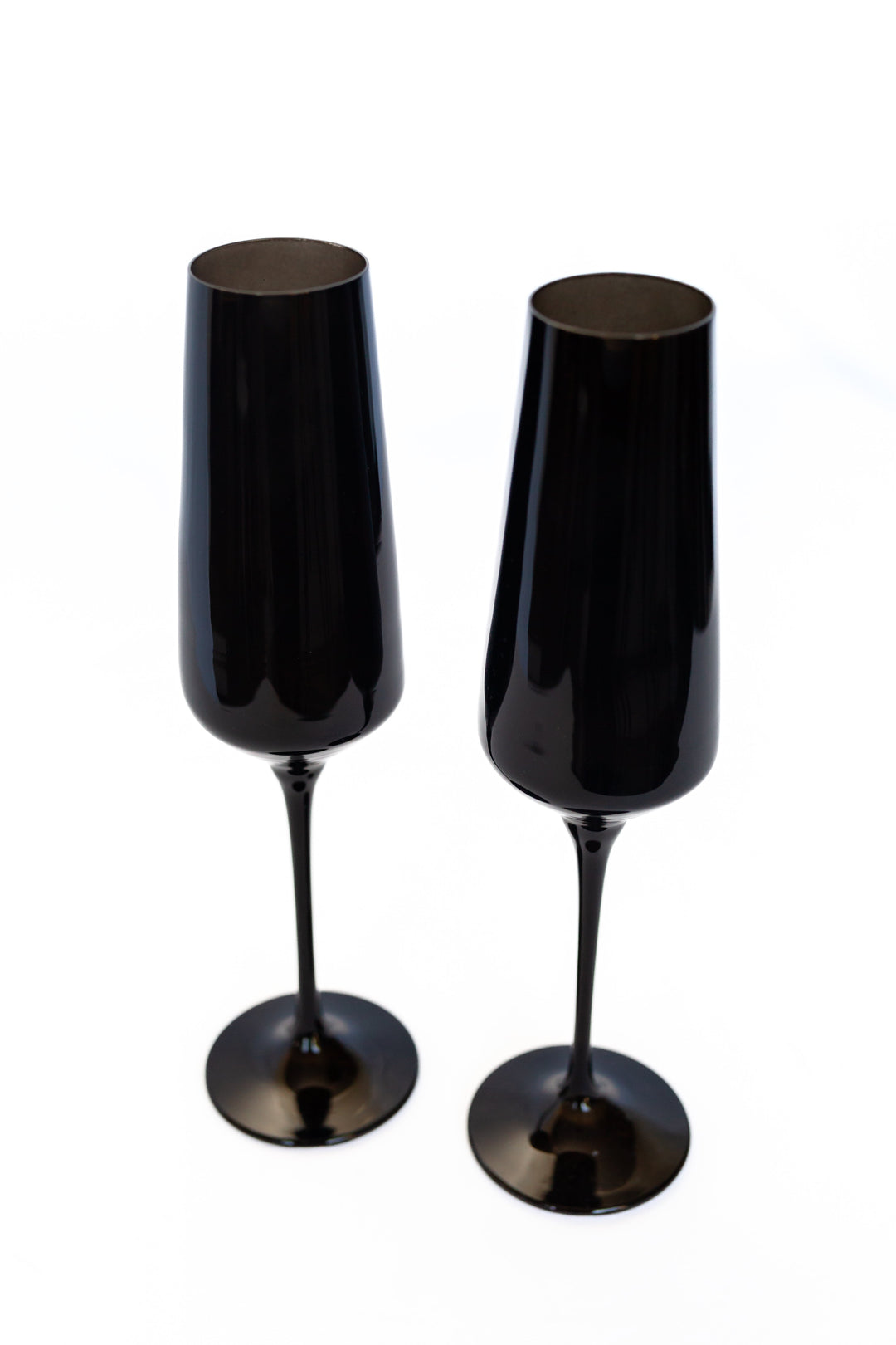 Two black champagne flutes on a white background