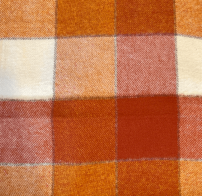 Close-up of the pumpkin spice plaid flannel, a large buffalo check in rust, cream, and dusty pink