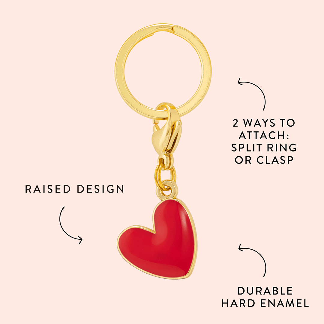 Red heart charm callout on blush noting the raised design and durable hard enamel