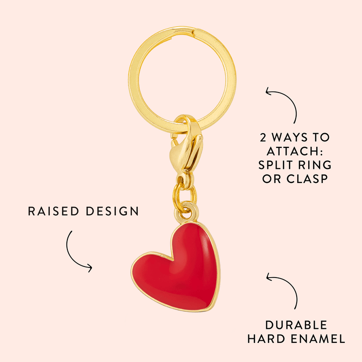 Red heart charm callout on blush noting the raised design and durable hard enamel
