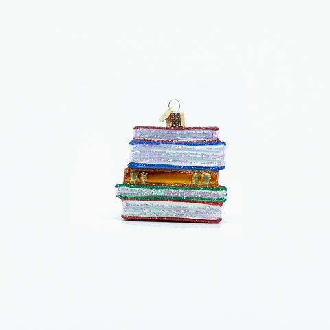 Stack of books ornament angled to show orange and gold spines and sparkling pages